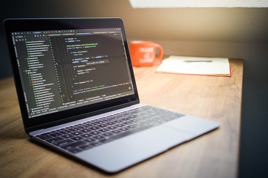 Laptop screen displaying code with a mug nearby