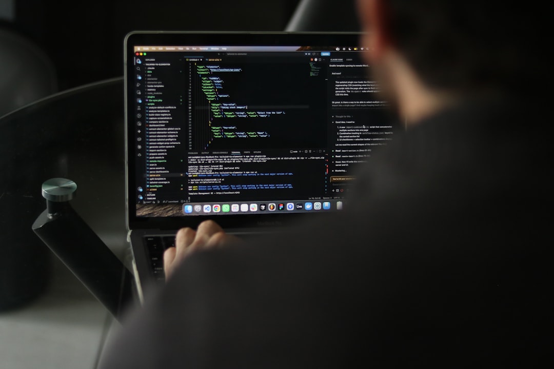 Developer typing code on a laptop screen