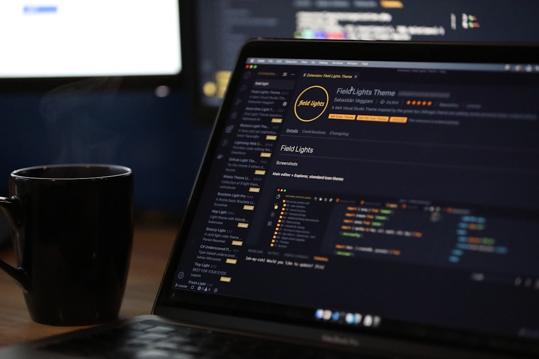 A laptop screen displaying code and a steaming mug on a desk