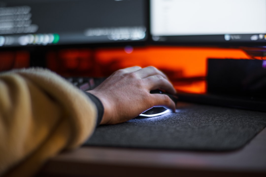 A person using a computer mouse on a desk